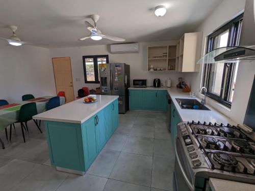 a kitchen with blue cabinets and a counter top at Casa Azul - Pedasi in Pedasí Town