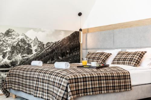 a bedroom with a bed with a picture of mountains at Domki przy Szlaku Pod Gubałówką in Zakopane