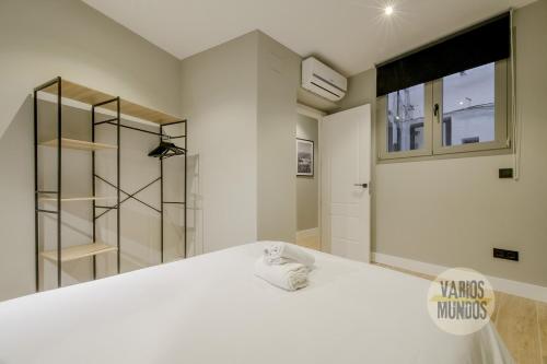 a bedroom with a large white bed and a window at Urban and Central Apt 5pax en Calle Silva-Gran Via in Madrid