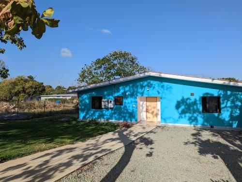 a blue building with a driveway at Casa Azul - Pedasi in Pedasí Town