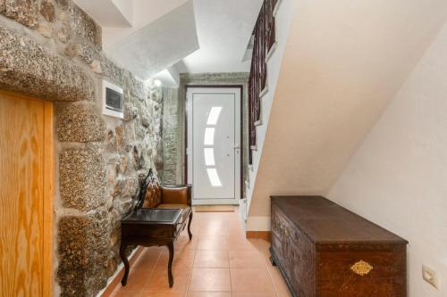 a room with a stone wall and a stair case at Rustic Getaway in Guarda in Gouveia