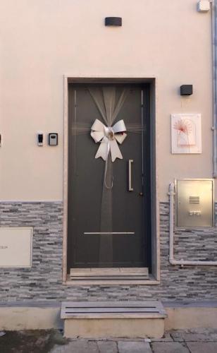 a black door with a flower on it at Casa Vacanze in Salento A casa di Benedetta in Squinzano