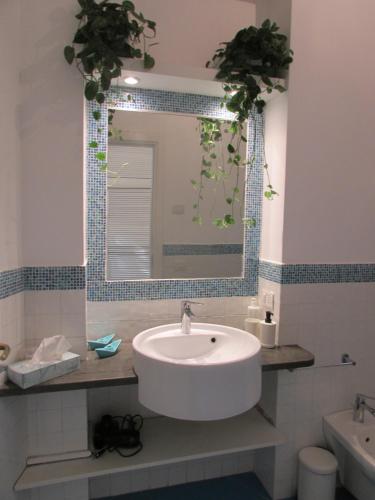 a bathroom with a sink and a mirror at Piazzetta Sweet Home in Capri