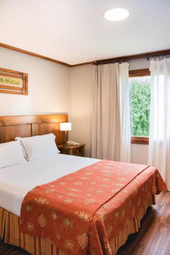 Postel nebo postele na pokoji v ubytování Rincón del Calafate