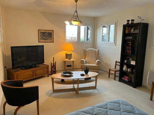 a living room with a television and a coffee table at Villa Seaview in Pteleós