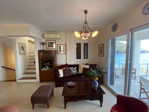 a living room with a couch and a table at Villa Seaview in Pteleós
