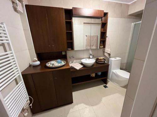 a bathroom with a sink and a toilet at Villa Seaview in Pteleós