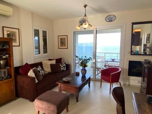 a living room with a couch and a table at Villa Seaview in Pteleós