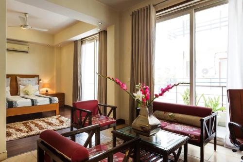 a living room with a couch and a table at Perch Service Apartment- Sector 40 in Gurgaon