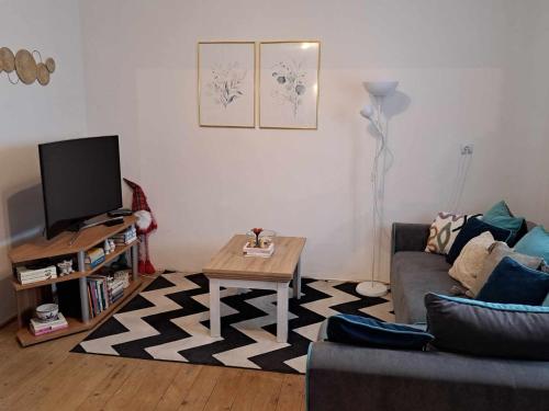 a living room with a couch and a coffee table at Cozy Town Center Retreat in Komárno