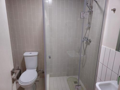 a bathroom with a shower with a toilet and a sink at Gudauri Vista 6 in Gudauri