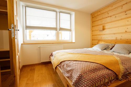 a bedroom with a bed and a window at Na Bogówce in Zakopane