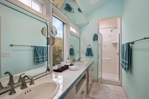 a bathroom with two sinks and a large mirror at SH157 Chase-n-Grace in Southern Shores