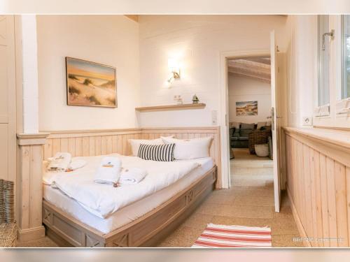a bedroom with a bed with two towels on it at Strandhaus Fischer in Prerow