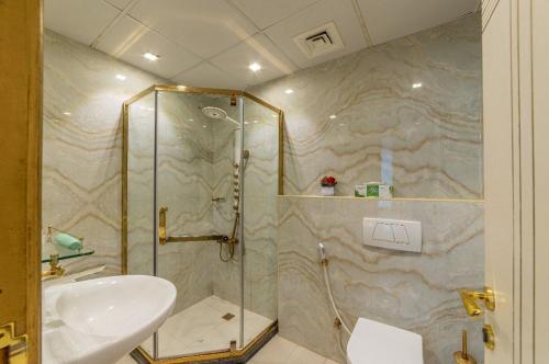 a bathroom with a shower and a sink at Royalton - Chic 2BR Marina Pinnacle Apartment with City Views in Dubai