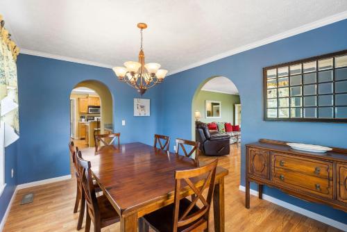 a dining room and living room with a table and chairs at Llama House in Omaha