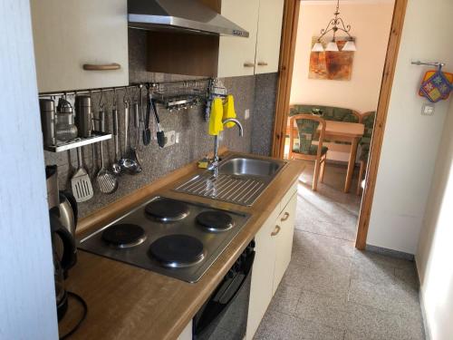a kitchen with a sink and a stove top oven at Haus-Koralle-Wohnung-rechts in Boltenhagen
