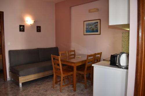 a living room with a table and a couch at Eden Beach Hotel in Agia Marina Nea Kydonias