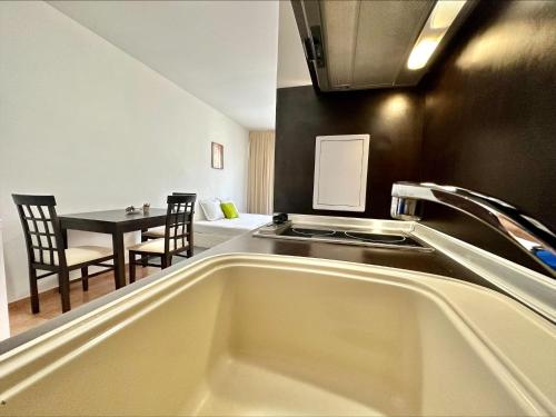 a kitchen with a sink and a table in a room at Menada Apartments in Marina Cape in Aheloy
