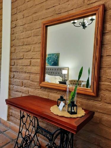 a mirror on a wall with a table with a mirror at Luna de Cafayate Hotel Boutique in Cafayate