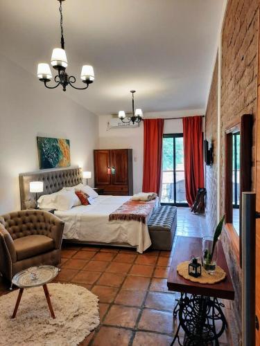 a large bedroom with a bed and a couch at Luna de Cafayate Hotel Boutique in Cafayate