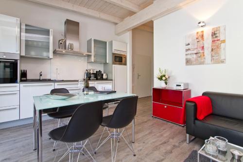 a kitchen and living room with a table and chairs at Domizil am Hang App A04 in Heringsdorf