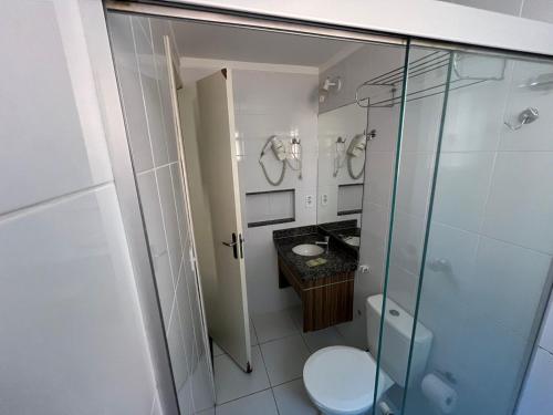a bathroom with a toilet and a glass shower at Lacqua di Roma IV Caldas Novas in Caldas Novas
