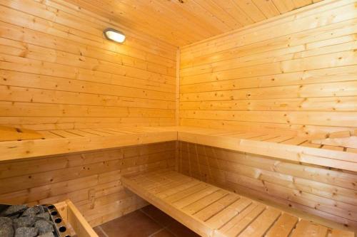 a wooden sauna with a bench in it at Ferienhaus Gut Landleben in Gellenthin