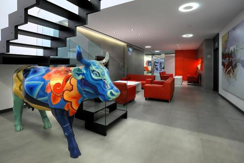 a lobby with a statue of a cow on the floor at Hotel Turin Barcelona in Barcelona