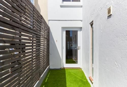 a hallway of a house with a green lawn at Stylish flat central Brighton in Brighton & Hove