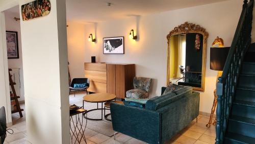 a living room with a couch and a table at Villa Yollande in Arcachon