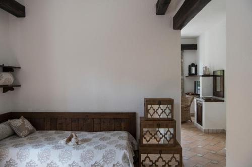 a bedroom with a dog laying on a bed at La Meridiana ReIais & Chateaux in Garlenda