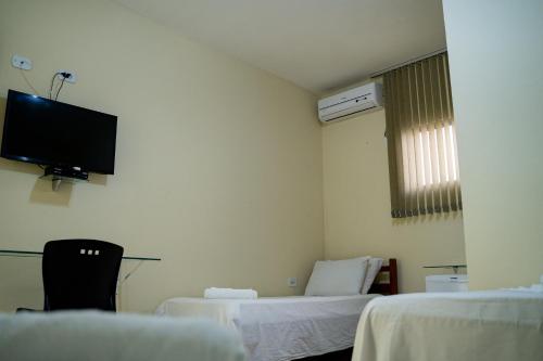 Ένα ή περισσότερα κρεβάτια σε δωμάτιο στο Hotel Santos