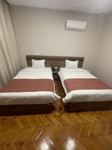 two beds sitting next to each other in a room at New Lotus Hotel in Cairo