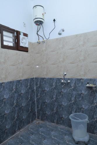 y baño con ducha y aseo. en Hotel Rudra en Dehradun