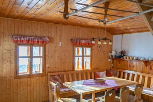 a wooden dining room with a table and chairs at Chalupa Na Sklepě in Velké Karlovice