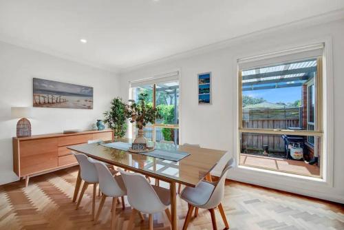 a dining room with a table and chairs and a window at Tranquil Escape by Ready Set Stay in Dromana