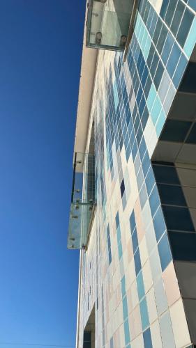 a tall building with glass windows on the side of it at Aveiro History Apartments in Aveiro