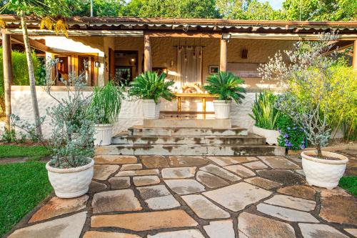 a patio with potted plants in front of a house at Pousada Cavaleiro dos Pireneus in Pirenópolis
