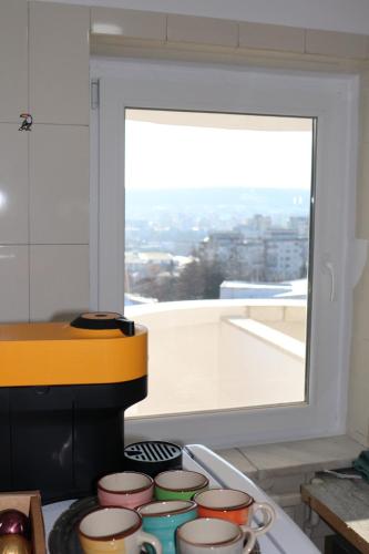 a kitchen with a stove top with a window at Propriete no.6 - close to university, hospital and downtown in Iaşi