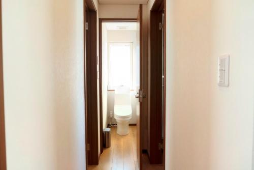 a bathroom with a toilet and a window at Niseko White Villas1 in Niseko