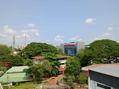 a view of a city with trees and buildings at Alite Enclaves Fully furnished apartments in Trichūr