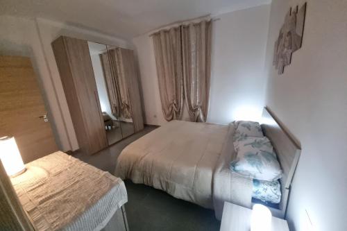 a bedroom with two beds and a mirror at ADRIANA SEAHOUSE in Balestrate