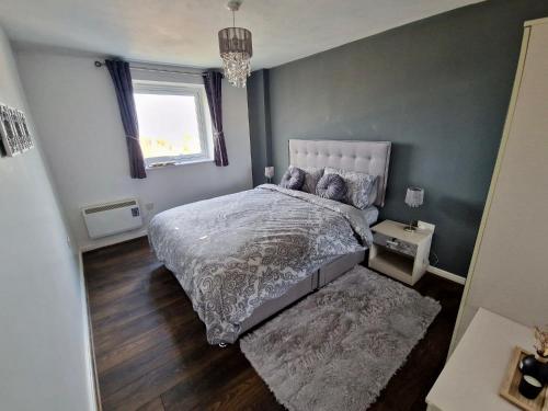 a bedroom with a bed and a window at 1-Bedroom Flat Close to Manchester Airport in Handforth