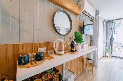 a small kitchen with a counter and a mirror at Sea Sand See Sky Beach Front Resort in Phuket