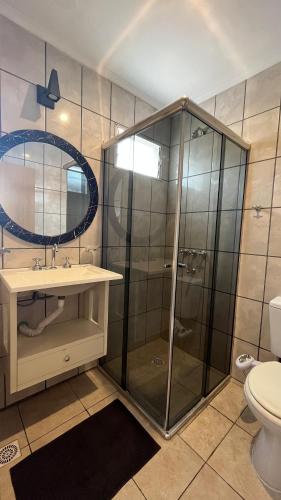 a bathroom with a shower and a sink and a toilet at Departamento El Caminante in Oberá