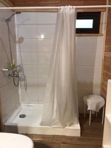 a shower with a white shower curtain in a bathroom at Cabaña Pucón in Pucón