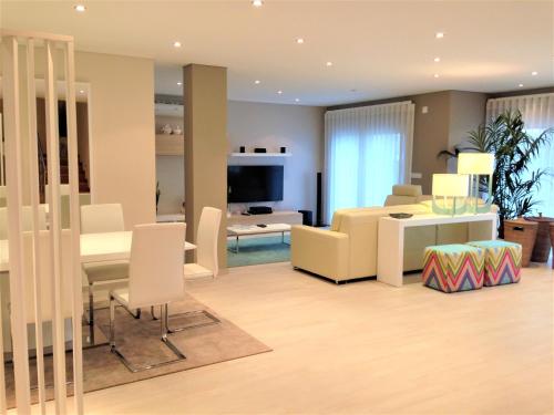 a living room with a table and a dining room at Holiday Calm Villa - Beach & Pool in Atouguia da Baleia