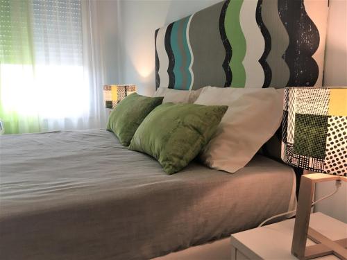 a bed with four pillows on it in a bedroom at Holiday Calm Villa - Beach & Pool in Atouguia da Baleia