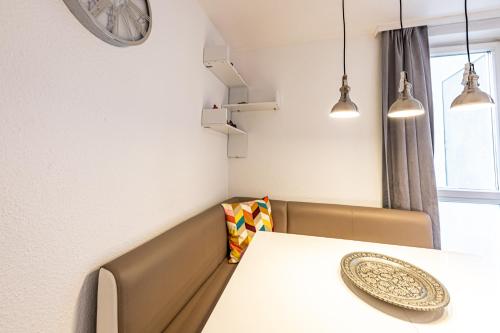 a dining room with a white table and chairs at CALM & CONNECTED by JR City Apartments in Vienna